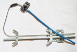 A Mercedes-Benz window regulator with a blue cable and metal components.